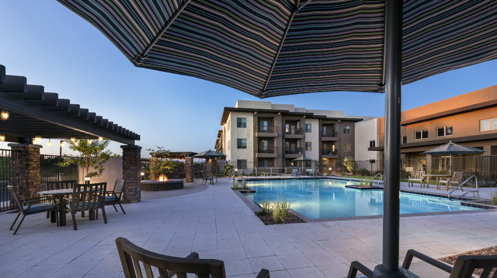 Inspira Arrowhead outdoor common area with seating for many and beautiful pool for residents