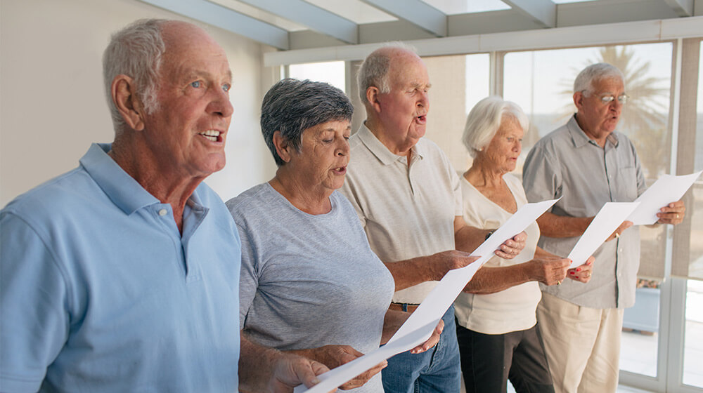 Five elderly people sing in a choir