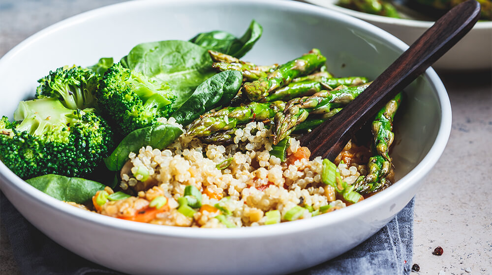Quinoa bowl with broccoli asparagus and delicious sauce
