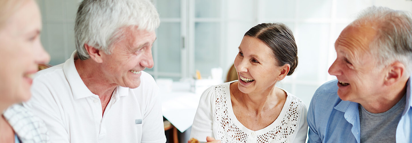 Mature friends gather for lunch and share laughs