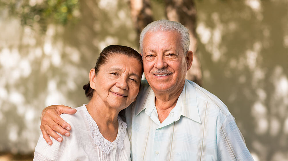 Portrait of a senior couple smiling together in a park