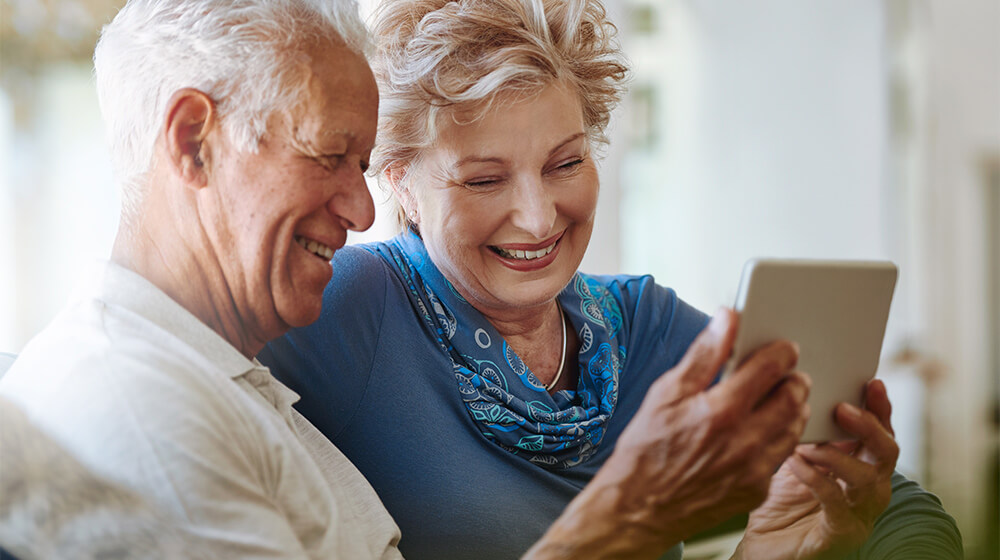 Shot of a happy senior couple using a digital tablet together on the sofa at home