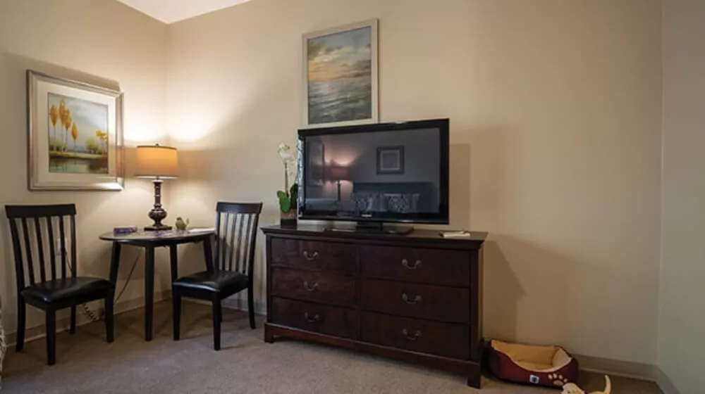 Bedroom with cozy living arrangements and a TV stand at Cadence Lakewood in Colorado