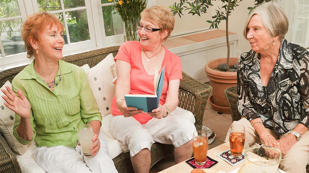 A group of senior women Reading and discussing together in a social book club.