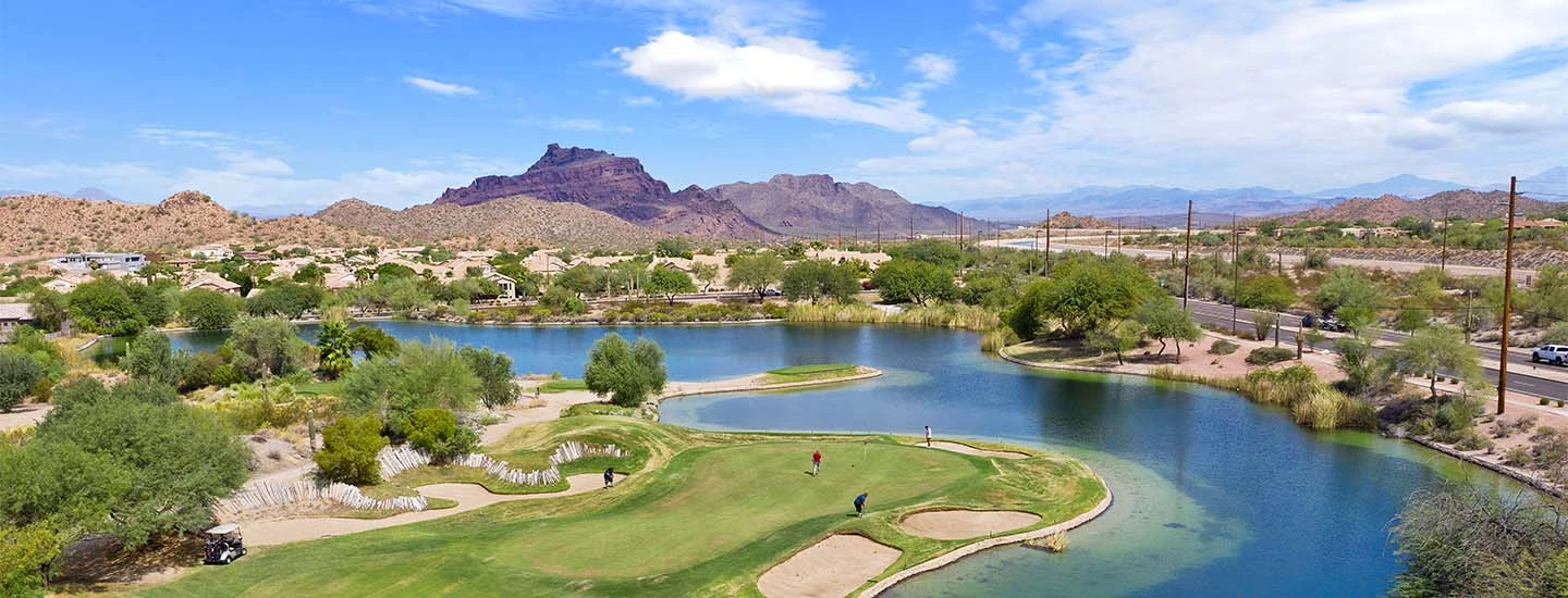 Arial view of golf course against the desert mountains outside of ACOYA Mesa